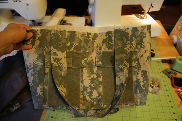 ... around the top to attach the lining to the bag, catching the handles